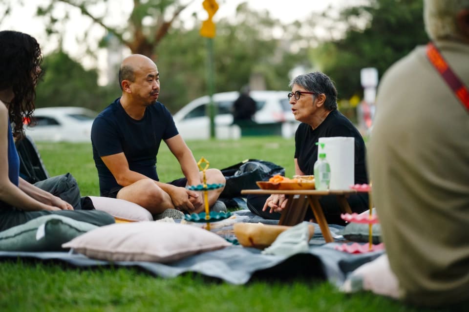 A man and a woman talking at a picnic
